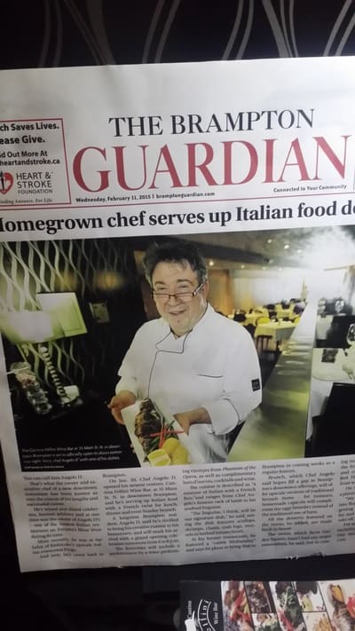 A copy of The Brampton Guardian with a large photo of a chef holding a plate